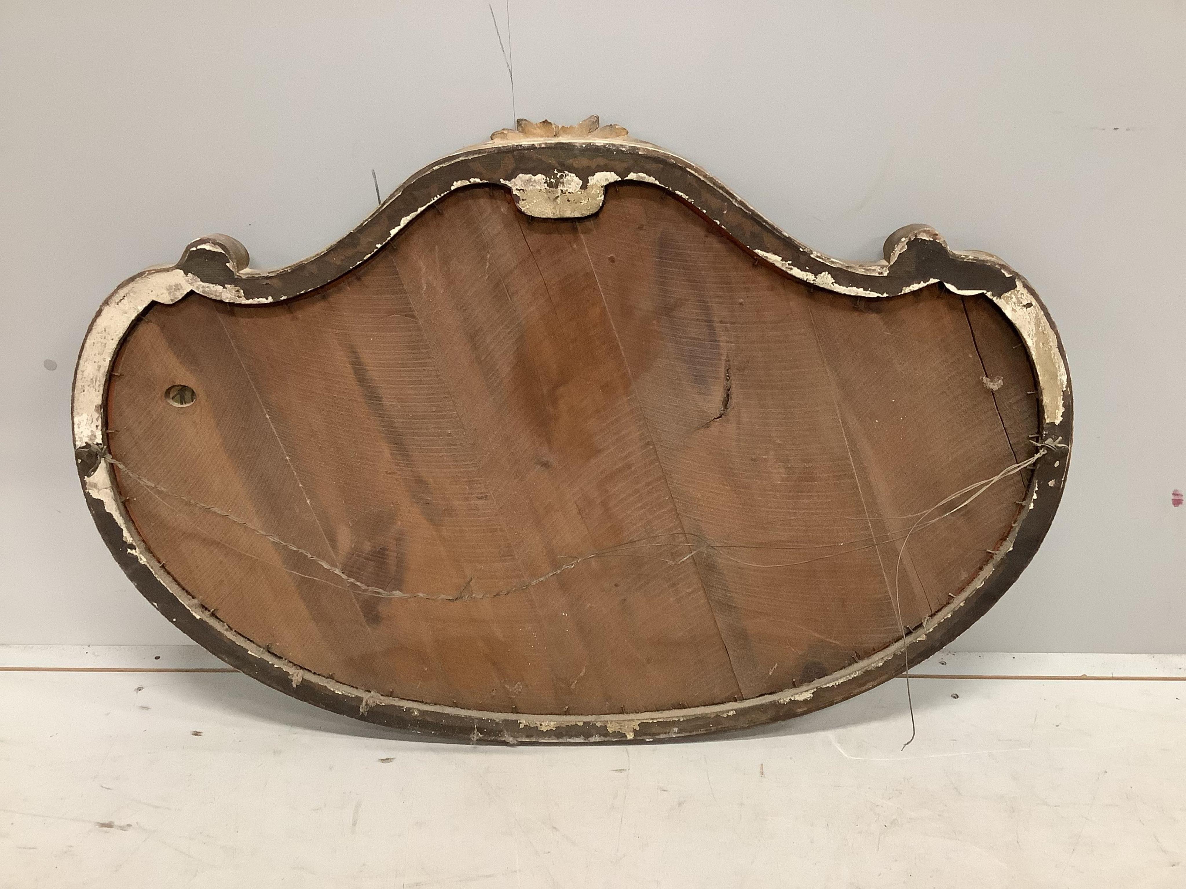 A Victorian giltwood and composition cartouche wall mirror, width 113cm, height 76cm. Condition - poor, losses to pediment and gilding.